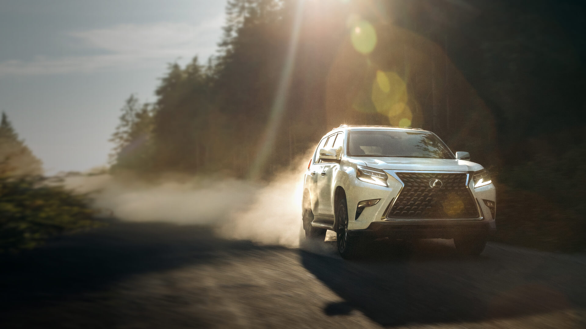 White Lexus GX being driven on the road.