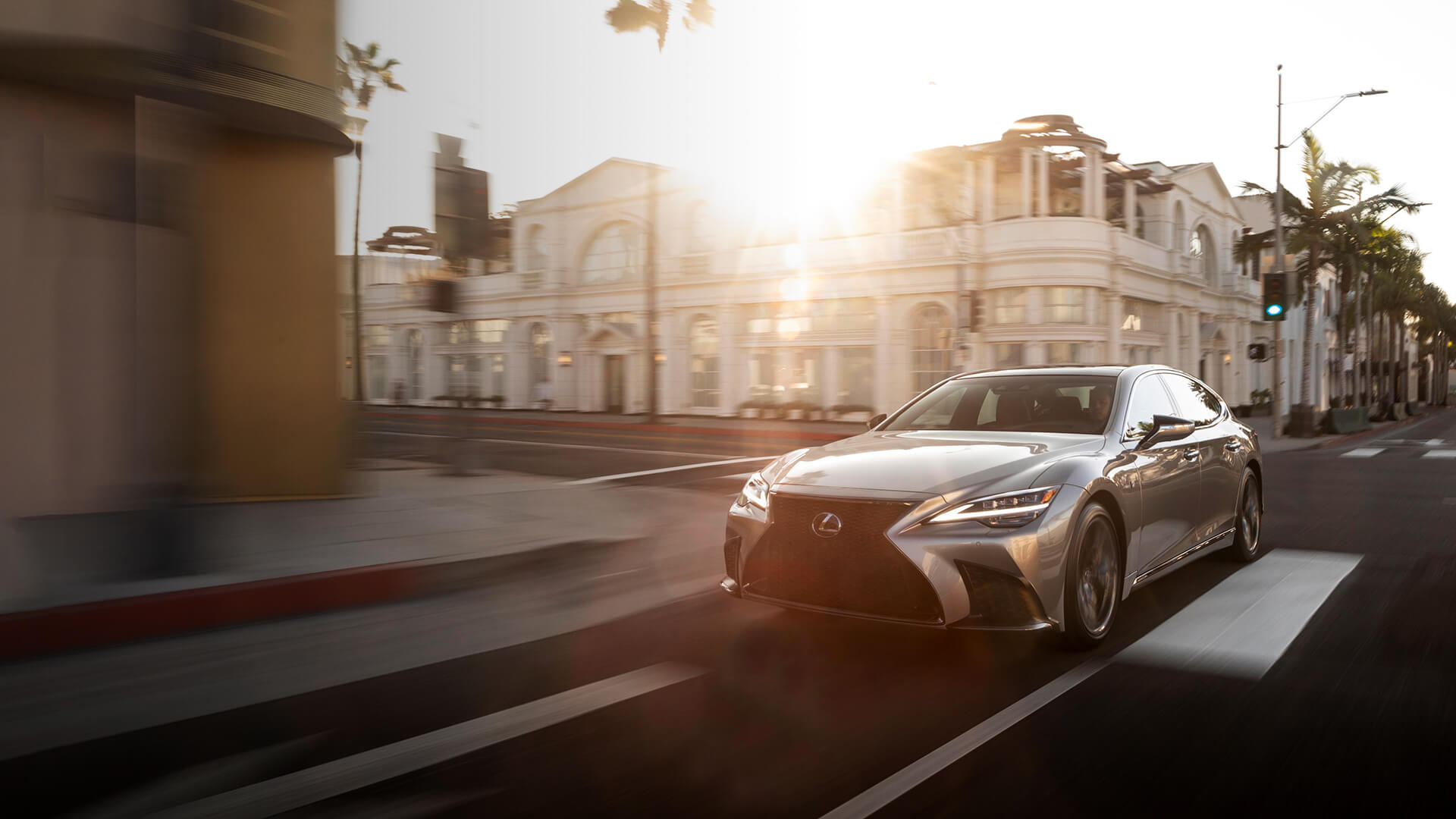Silver Lexus LS being driven on the road.