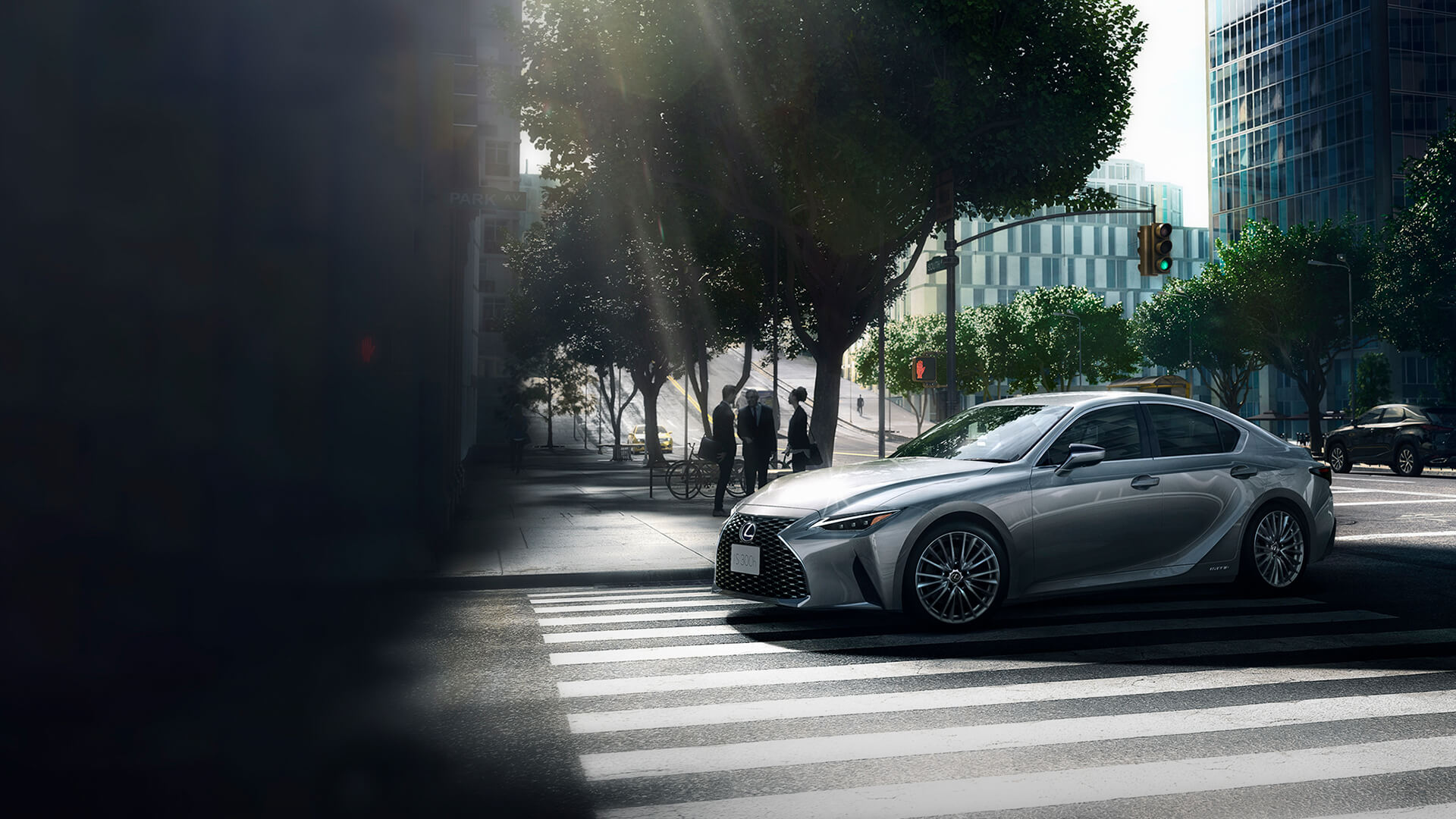 Silver Lexus IS being driven on the road.