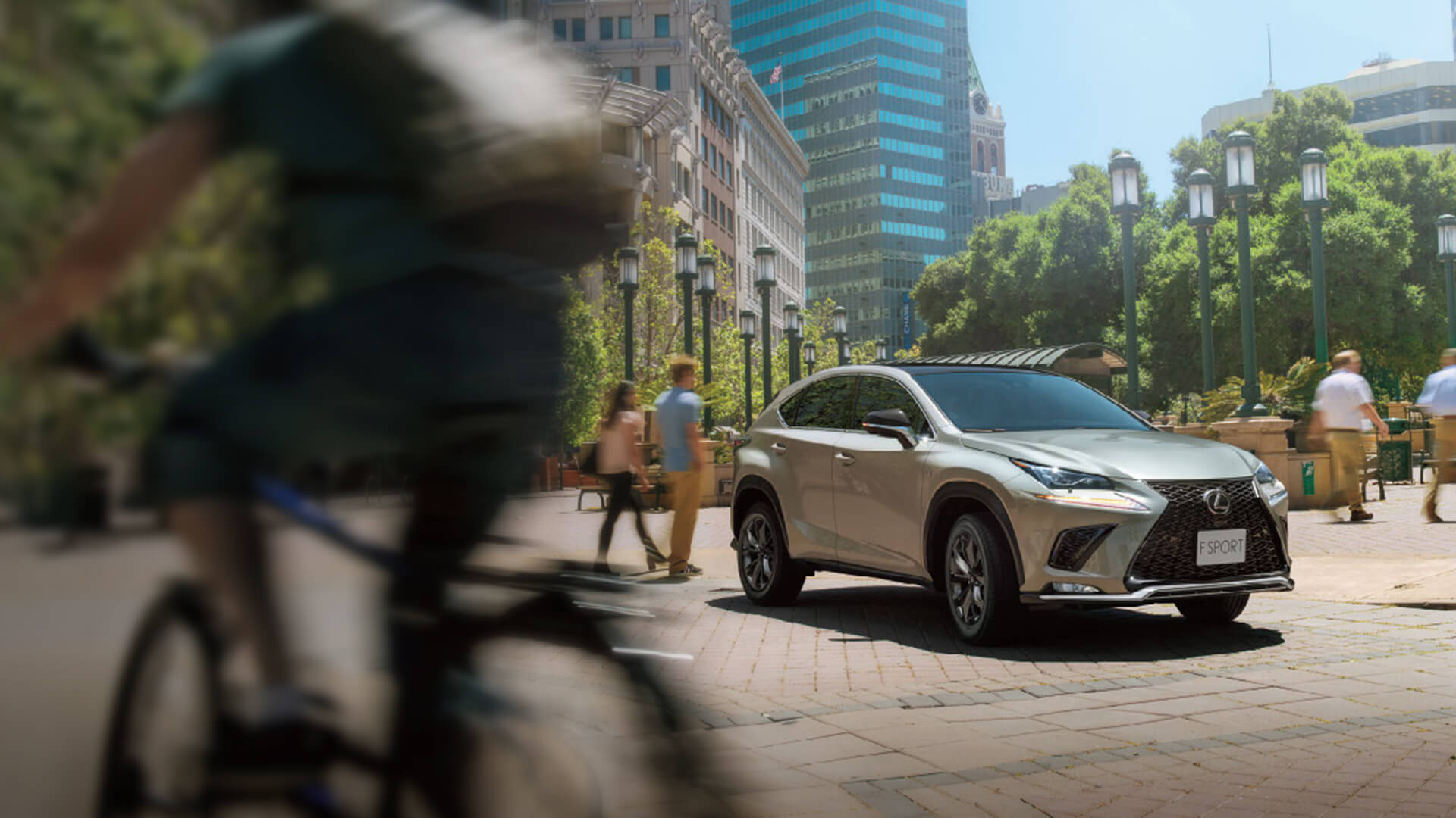 White Lexus NX being driven in the city.
