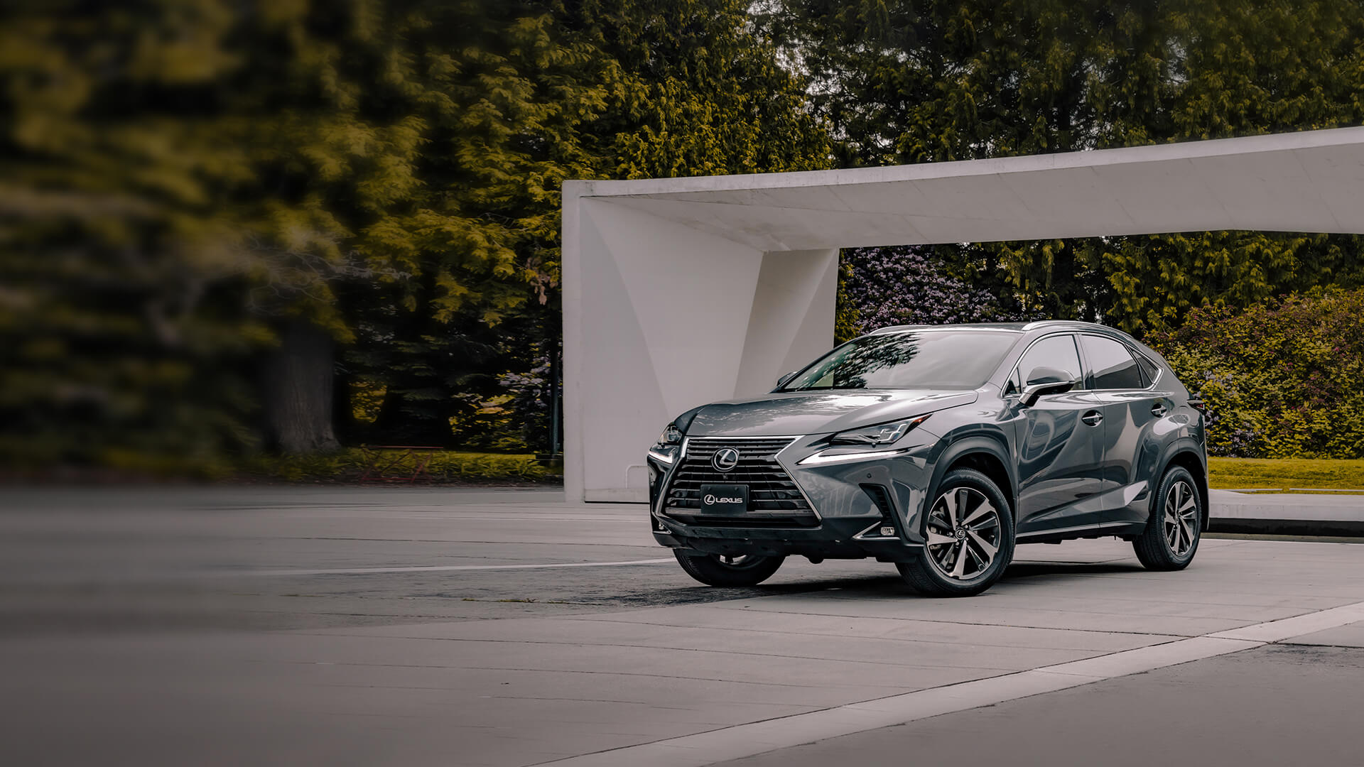 Silver Lexus NX being driven on the road.